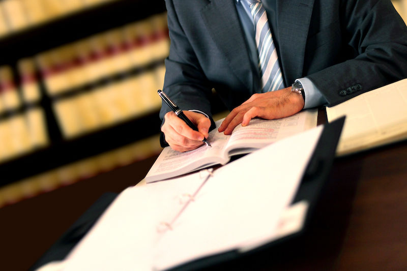 Man in suit writing with a fountain pen