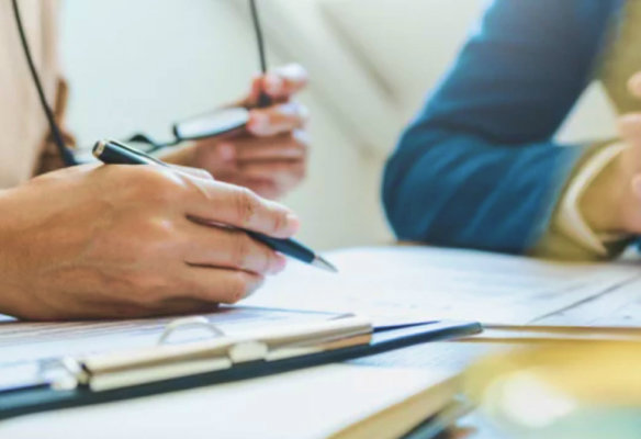 Photo of people writing documents